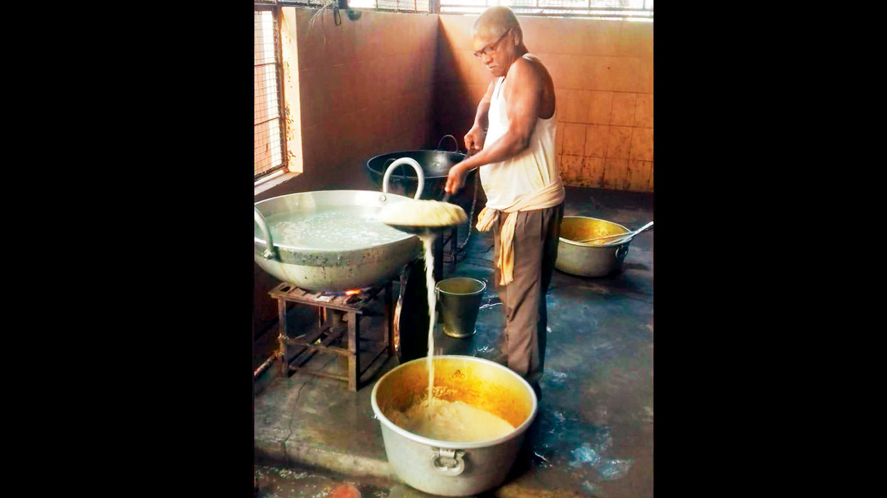 Veteran writer and MLA Manoranjan Byapari working in the kitchen